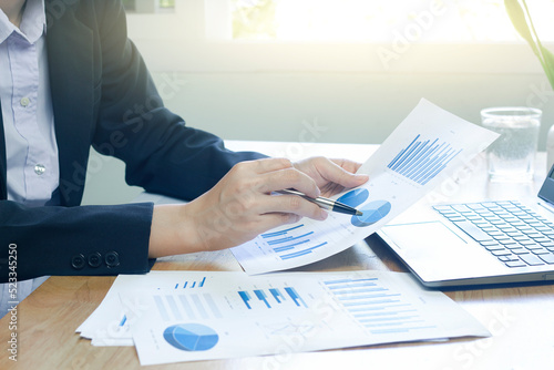 Woman arm holding silver pen point in Marketing financial graph solving. Situation examination at board council sale adviser job stock exchange market profit.