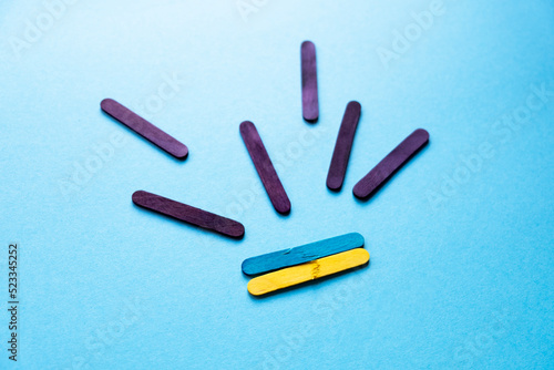 war in Ukraine. Broken Ukrainian flag on a blue background. Rockets fly to Ukraine. Painting from colored sticks