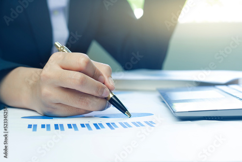 Woman arm holding silver pen point in Marketing financial graph solving. Situation examination at board council sale adviser job stock exchange market profit.