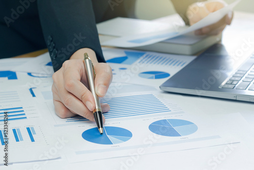 Woman arm holding silver pen point in Marketing financial graph solving. Situation examination at board council sale adviser job stock exchange market profit.