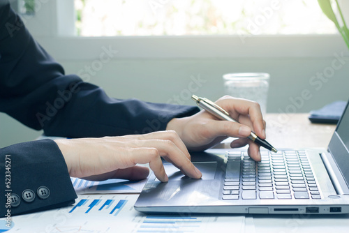 Close-up of a business woman analyzing charts and graph showing changes on the market.working in office firm business info.