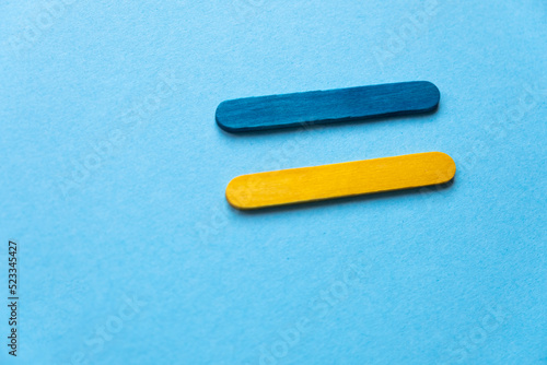 Flag of Ukraine from colored sticks on a blue background