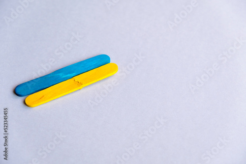 broken flag of ukraine on a gray background free space. Blue and yellow colors