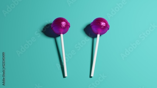 Purple caramel lollipops on sticks isolated on blue background. 3D rendering,  © Artem