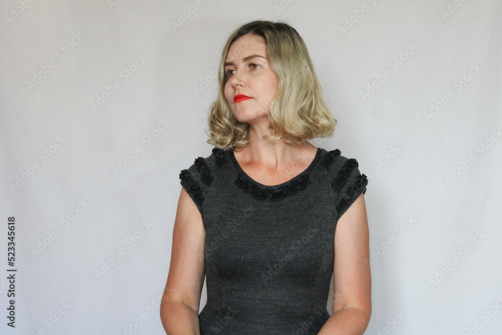 Beautiful middle-aged blond woman on a white background Beautiful middle-aged blond woman on a white background