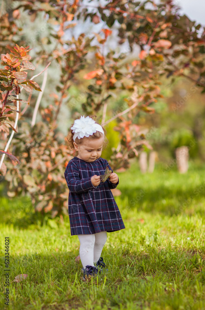Little girl in plaid dress eating croissant Childhood concept. Little girl in plaid dress eating croissant Childhood concept.