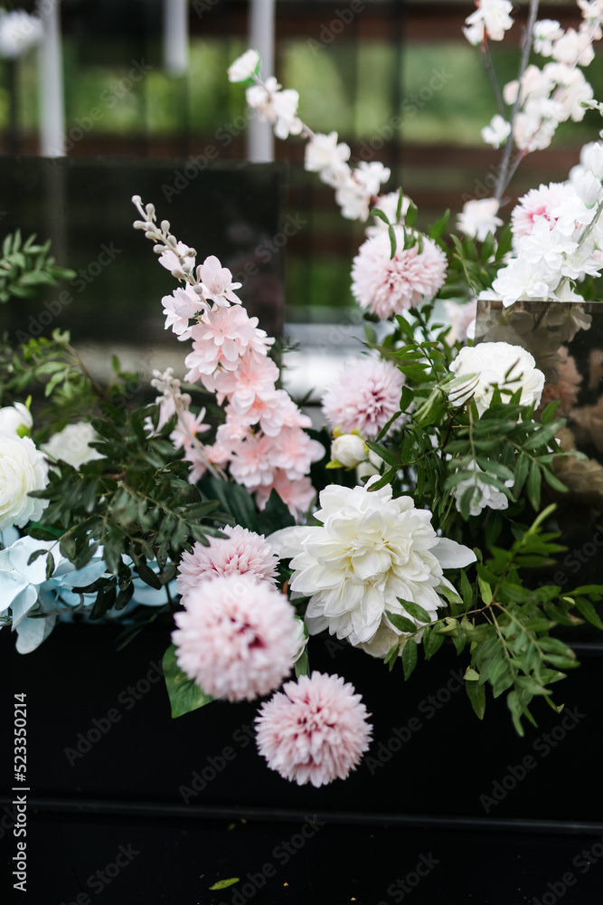 A composition of artificial flowers at the celebration. wedding decor in blue and pink tones in nature. A composition of artificial flowers at the celebration. wedding decor in blue and pink tones in nature.