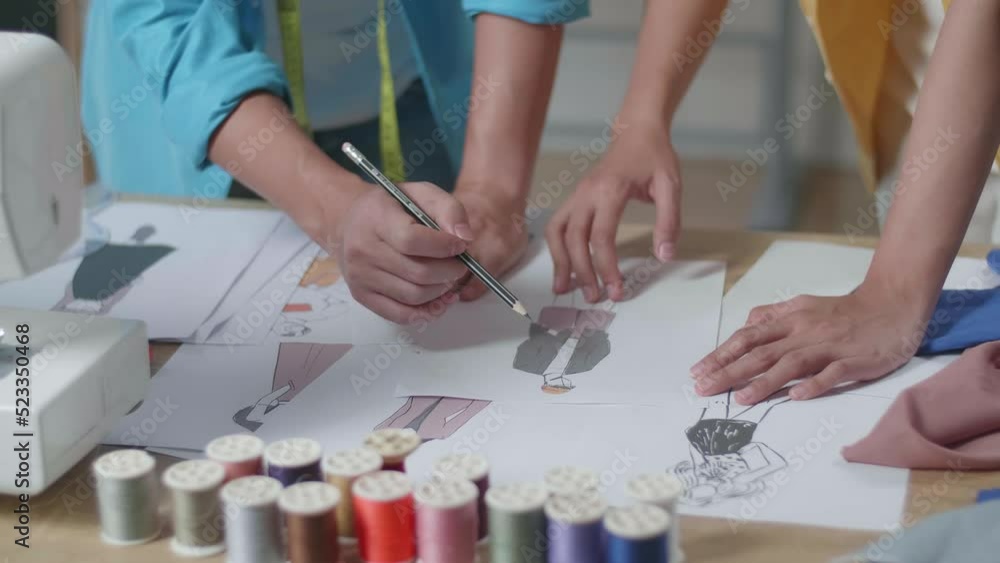 Close Up Of Male And Female Designers Hands Designing Clothes On The Paper In The Studio
Close Up Of Male And Female Designers Hands Designing Clothes On The Paper In The Studio