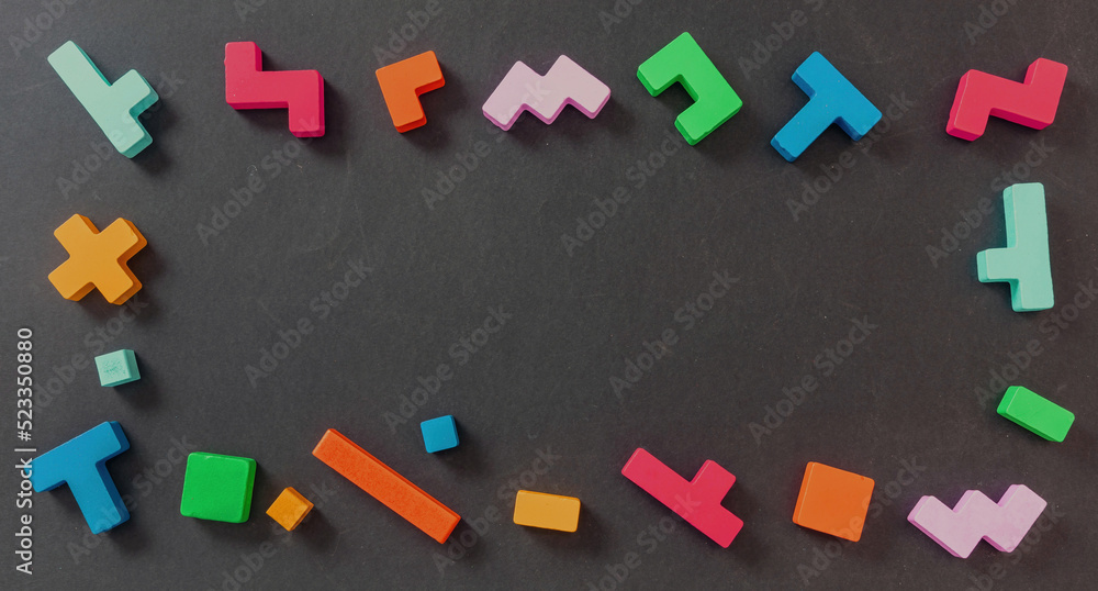 Creative kids play. Wood toy block frame. Colorful pieces on black color, copy space. Creative kids play. Wood toy block frame. Colorful pieces on black color, copy space.