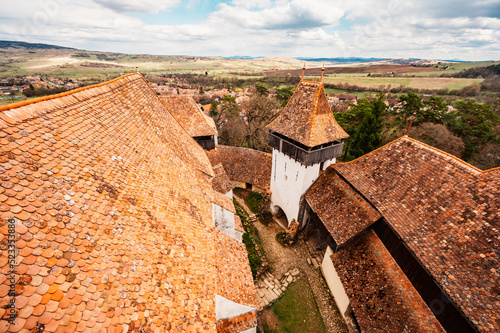 Viscri, Romania: Blue old painted traditional house from village, Transylvania, German Saxon community. Unesco. The Viscri fortified church photo