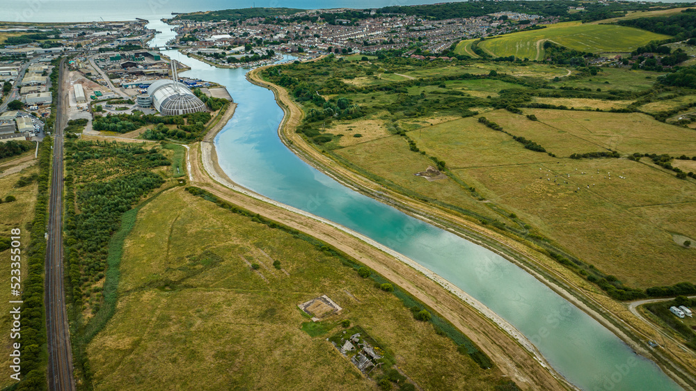 Aerial view of river going through the town right into sea, Peacehaven, East Sussex, UK