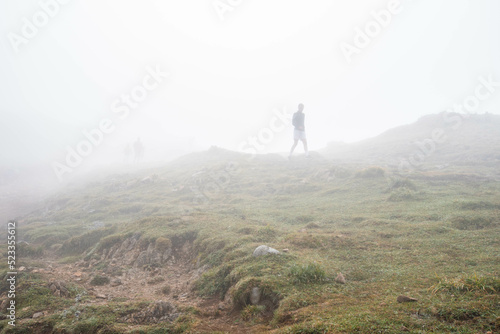 human silhouette in foggy mountains