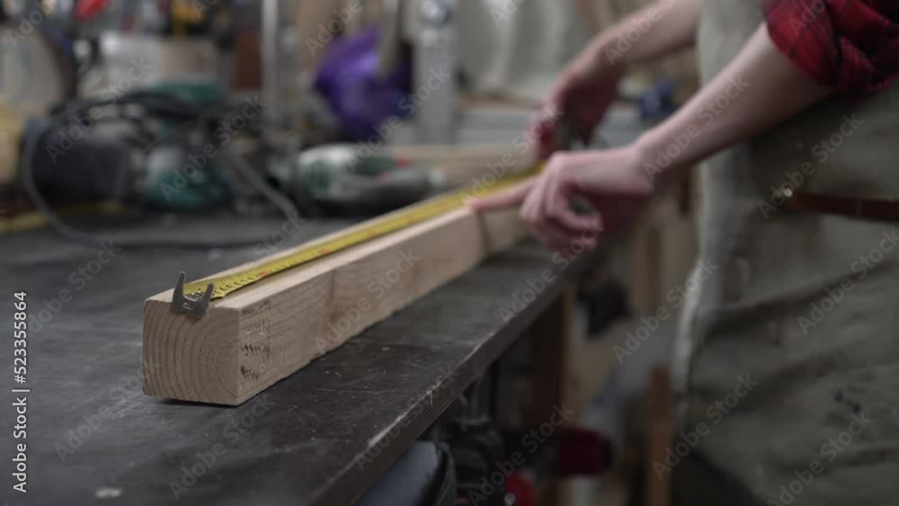Woman carpenter works in the workshop. The concept of equality of female and male labor, feminism Woman carpenter works in the workshop. The concept of equality of female and male labor, feminism