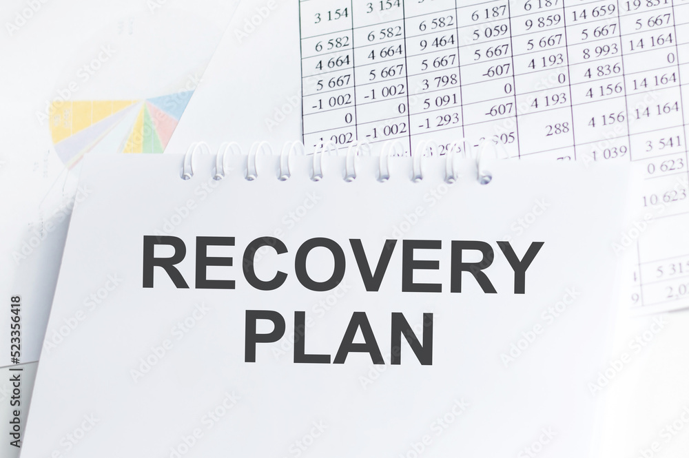 Fototapeta premium Recovery Plan inscription on a notebook on an office desk, a business concept