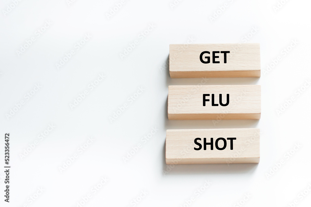 GET FLU SHOT text on three wooden bars on a white background GET FLU SHOT text on three wooden bars on a white background