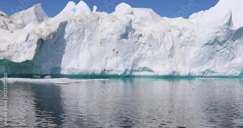 Wallpaper Mural Melting icebergs by the coast of Greenland, on a beautiful summer day - General view of iceberg and moutains from a moving boat - Greenland Torontodigital.ca
