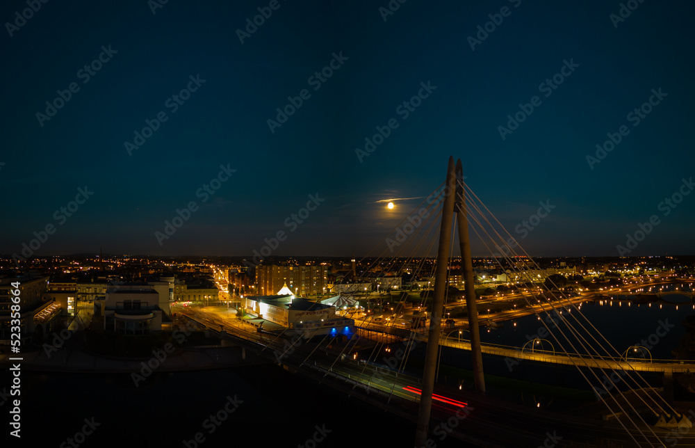 Aerial view of the Millennium Bridge over Southport Marine Lake at night with moon rise, Southport Merseyside