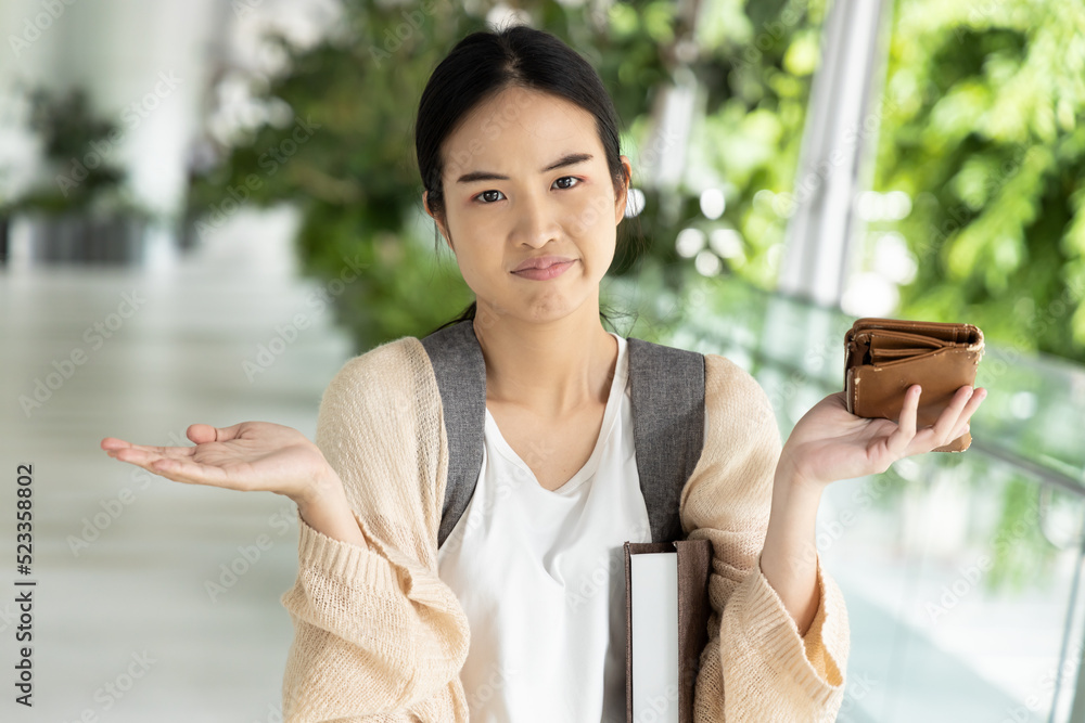 Asian student having no money, concept of high tuition fee, scholarship money, educational financial aid Asian student having no money, concept of high tuition fee, scholarship money, educational financial aid