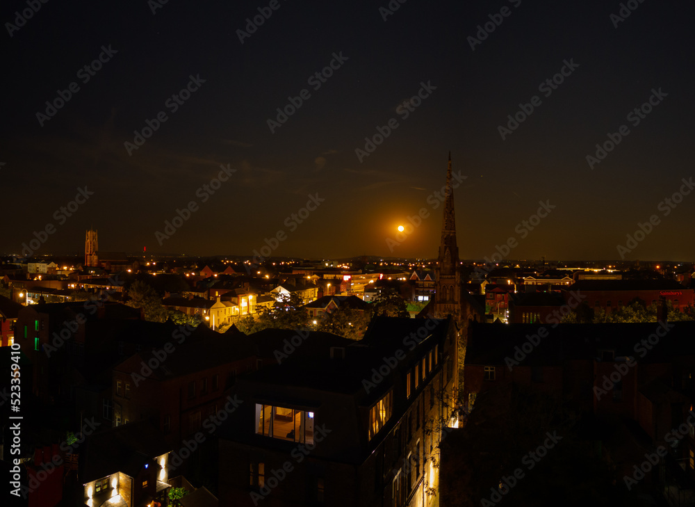 Fototapeta premium Aerial view of the spire of St. Georges church Southport at night with moon rise, Southport, Merseyside