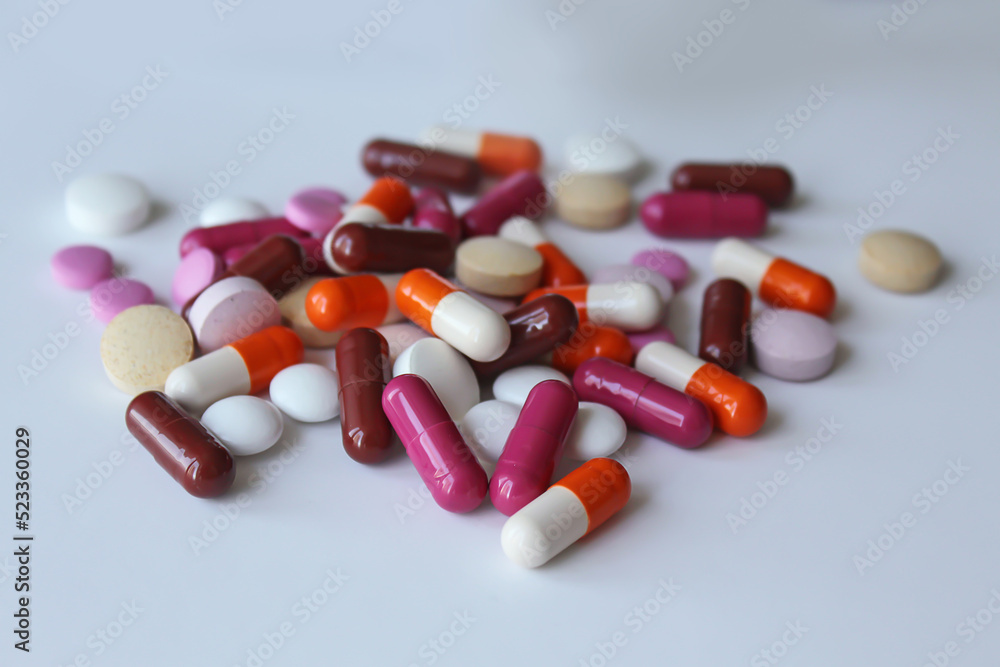 tablets and capsules on table background. tablets and capsules on table background.
