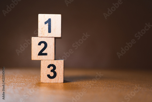 Wooden block number on sunlight using as business competition and education concept