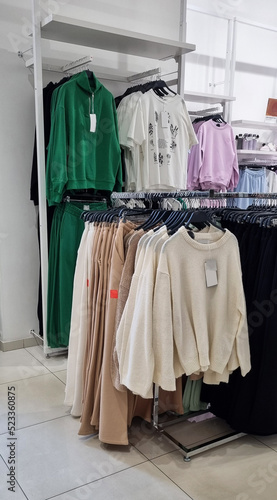 Clothes in the store on hangers.