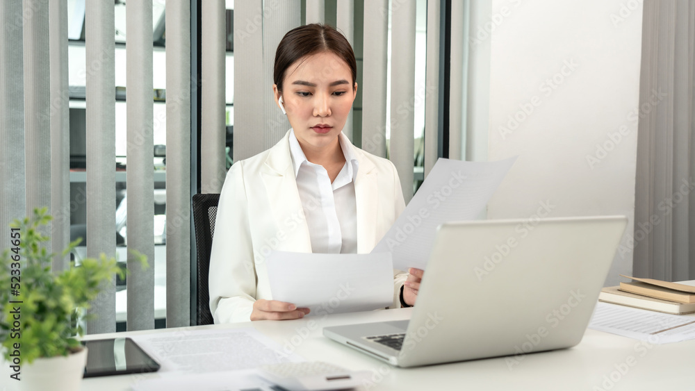 Professional businesswoman analyzing graph data from document in hand, Market research reports and income statistics, Woman working in a private office, Financial and Accounting concept Professional businesswoman analyzing graph data from document in hand, Market research reports and income statistics, Woman working in a private office, Financial and Accounting concept