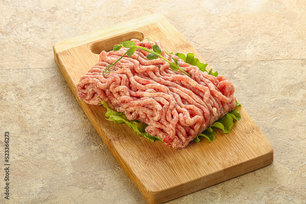 Raw minced pork meat over board