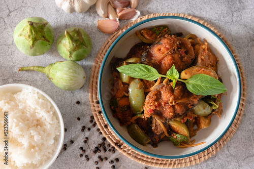 Top view stir fried spicy catfish with red curry paste, served with streamed jasmine rice as traditional food Thailand