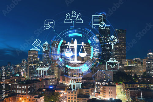 Illuminated aerial cityscape of Seattle, downtown at night time, Washington, USA. Glowing hologram legal icons. The concept of law, order, regulations and digital justice