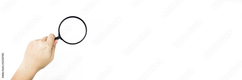 Top view of Hand holding a magnifying glass on white background. concept of business, search or select with blank banner space for copy Top view of Hand holding a magnifying glass on white background. concept of business, search or select with blank banner space for copy