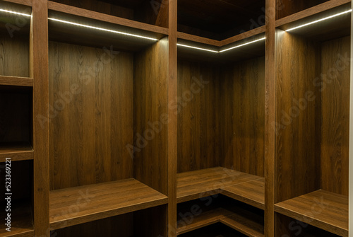 Big wardrobe room in modern apartment or hotel. large wooden locker room