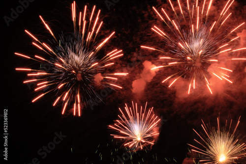 sparks and firework lights against dark night sky  pyrotechnic performance