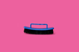 Brush for clothes on a bright pink background