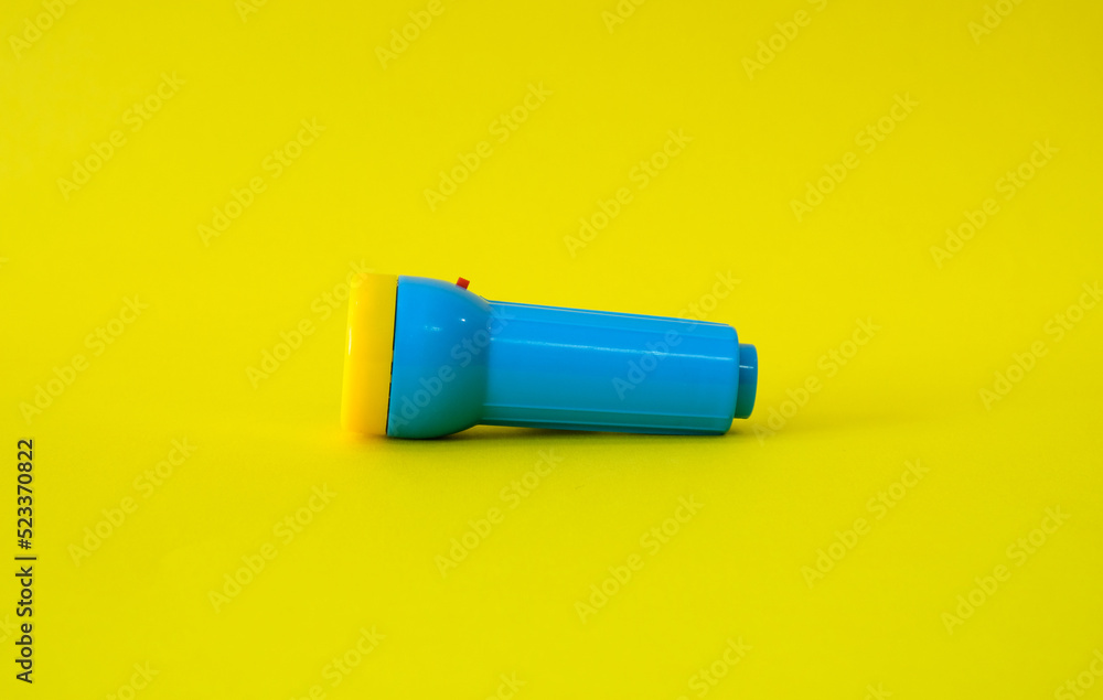Flashlight on a bright yellow background Flashlight on a bright yellow background