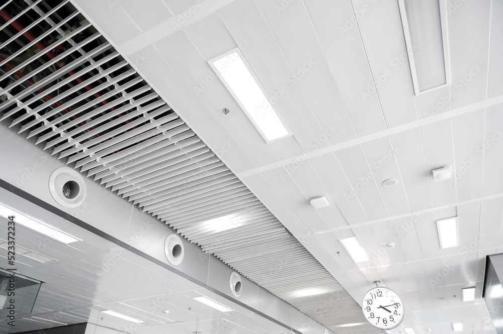 Foto de Ceiling mounted cassette type air conditioner and modern lamp ...