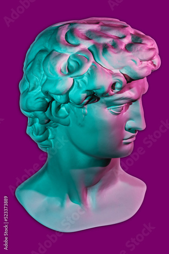 Gypsum copy of head statue David for artists. Plaster face of sculpture youth David before fight with giant Goliath by Michelangelo in bright neon color. Template design for dj, fashion, poster, zine.