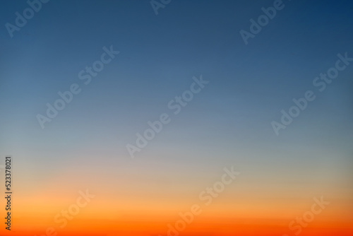 Fototapeta Naklejka Na Ścianę i Meble -  Orange and blue sunset sky gradient, copy space background. Red evening sky without clouds