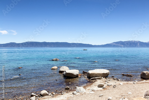 Beach with Sand and Rocks at Lake surrounded by Mountains. Summer Season. Sugar Pine Point Beach, Tahoma, California, United States. Sugar Pine Point State Park. Nature Background. photo