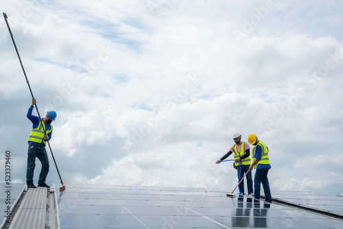 Solar power washing,labor working on cleaning solar panel at solar power plant. photo