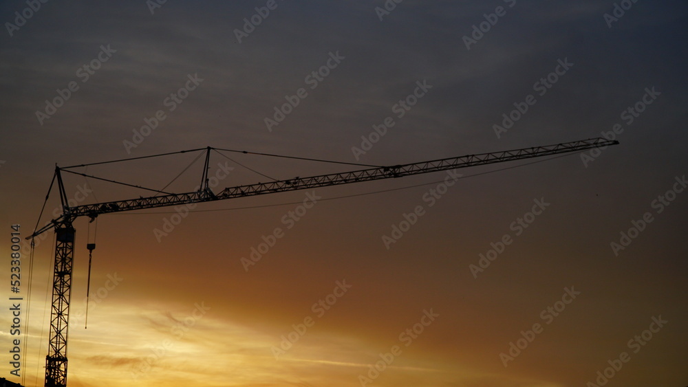 Tower crane silhouette on sunset background