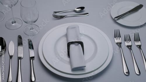 White plate fork and knife. Classic serving tableware on the table