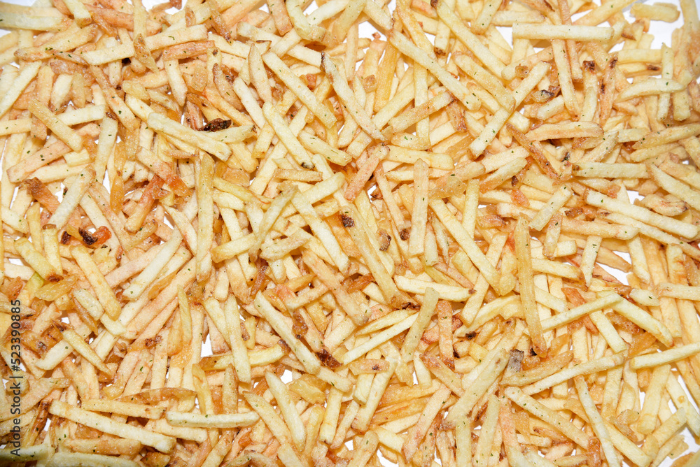 Fried French fries in close-up. Delicious salty fried potatoes. Fried French fries in close-up. Delicious salty fried potatoes.