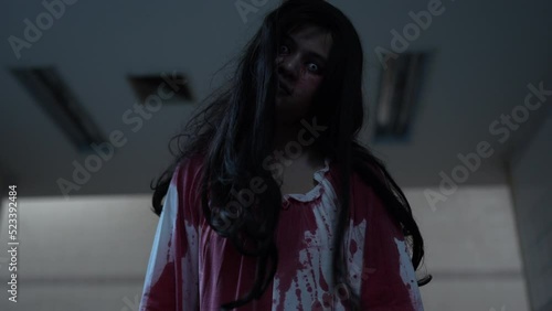 Ghost of woman in halloween concept. Zombie horror in the dark background nightmare screaming on hell is monster girl or female dead characters at night, Female with whitedress and makeup halloween.