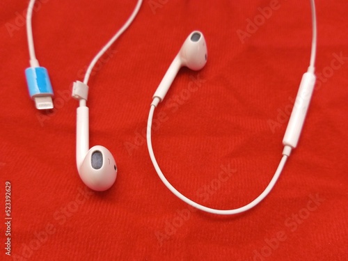 seen white earphones on a red background