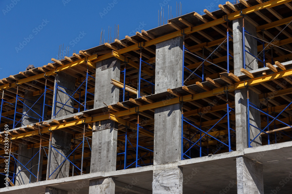 Construction of a residential building. Part of urban real estate and architecture. Facade of a residential building. Construction of a residential building. Part of urban real estate and architecture. Facade of a residential building.