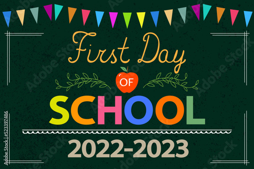 First Day of School greeting card. Text 2022-2023, red apple on school chalkboard with colorful garland. Back to school concept.	