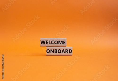 Welcome onboard symbol. Concept words Welcome onboard on wooden blocks. Beautiful orange background. Business and Welcome onboard concept. Copy space.