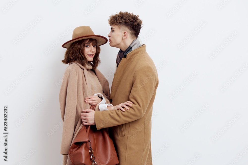 a happy couple is standing in autumn , stylish clothes and no need to hug each other looking at each other a happy couple is standing in autumn , stylish clothes and no need to hug each other looking at each other