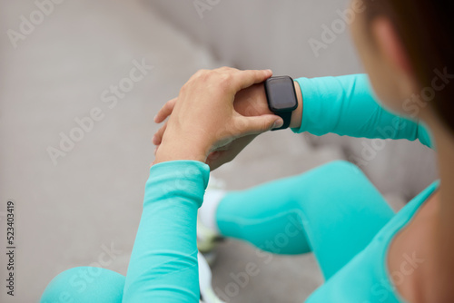 Sport. Fitness Girl Checks Tracker On Wrist Before Workout. Fashion Sporty Woman. Fit Female Monitoring Pulse On Smart Watch.